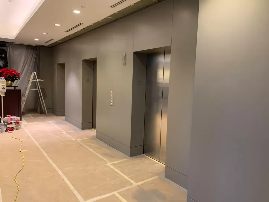 Elevator lobby at Aspiria Campus during renovation. Painted surfaces with floor protection still in place.