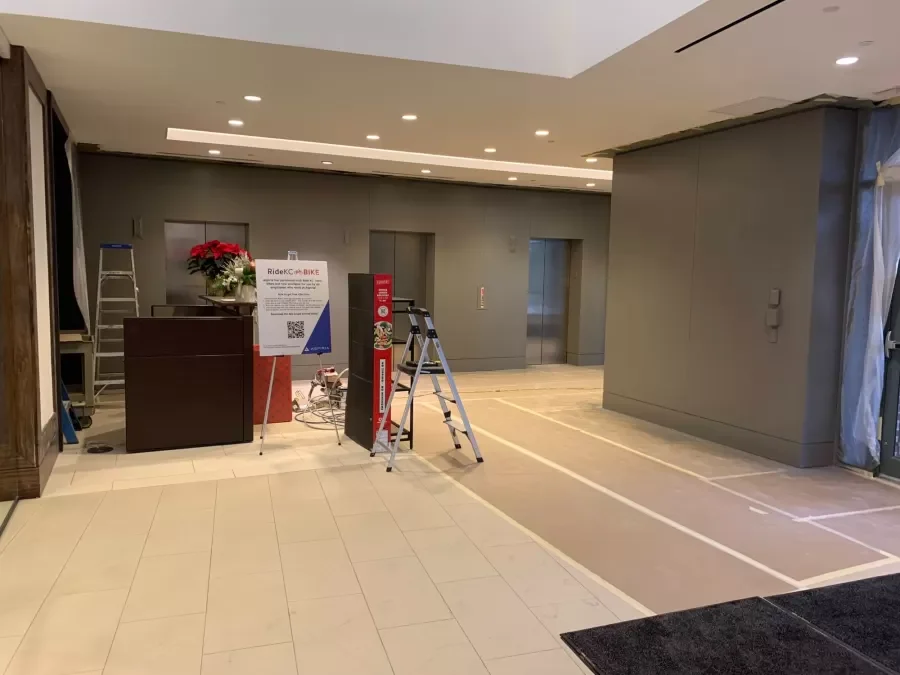 Reception area at Aspiria Campus during renovation. Fresh paint, ladders, and protected flooring.