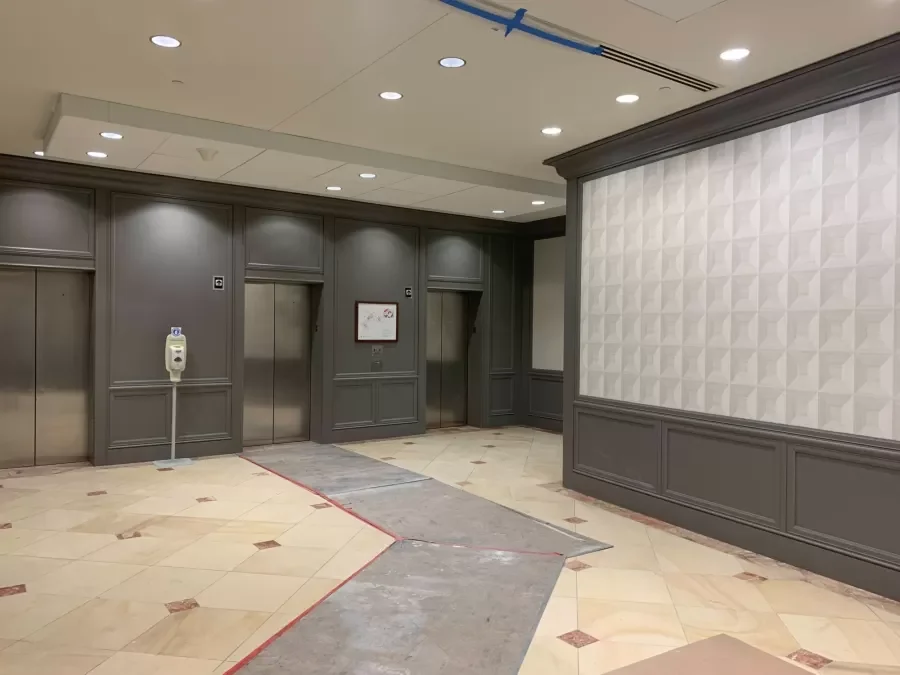 Elevator landing at Aspiria Campus during renovation. Wall finishes in place as flooring work continues.