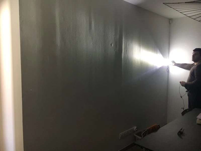 Wall surface and repairs revealed by light