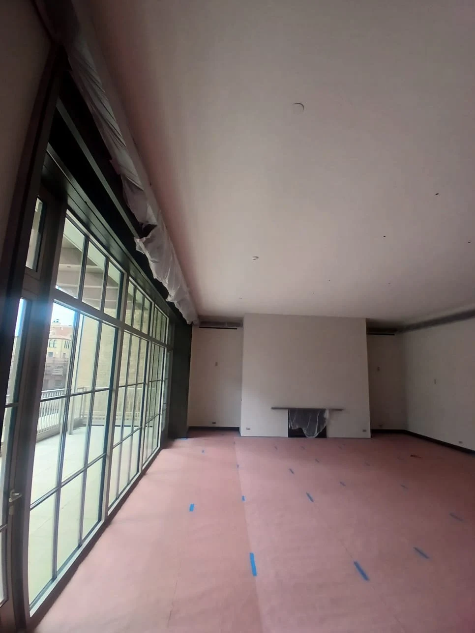 Floor covering and fireplace masking protect the room during painting.